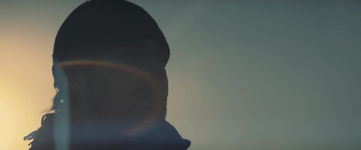 A man stands outside as the sun shines down on him