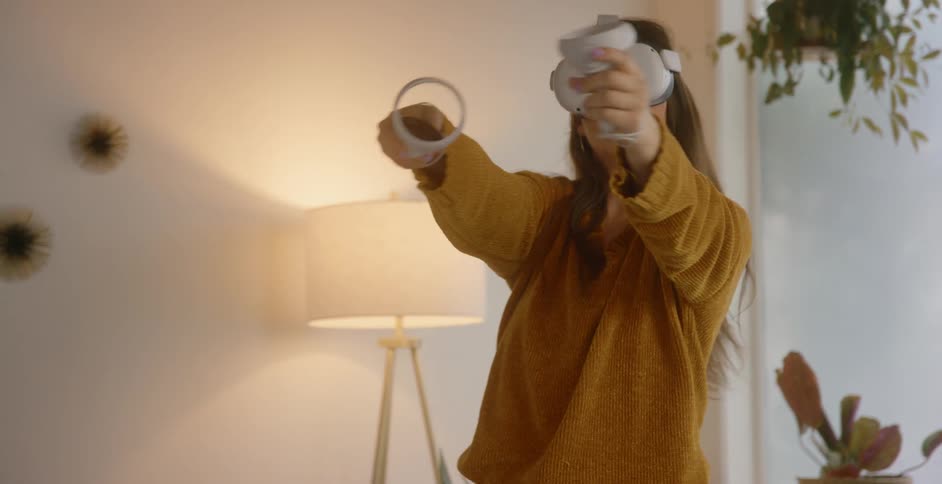 A woman plays a virtual reality game at home