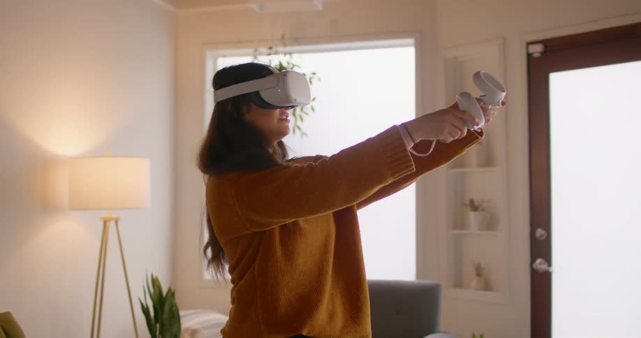 A woman is playing virtual reality game indoors