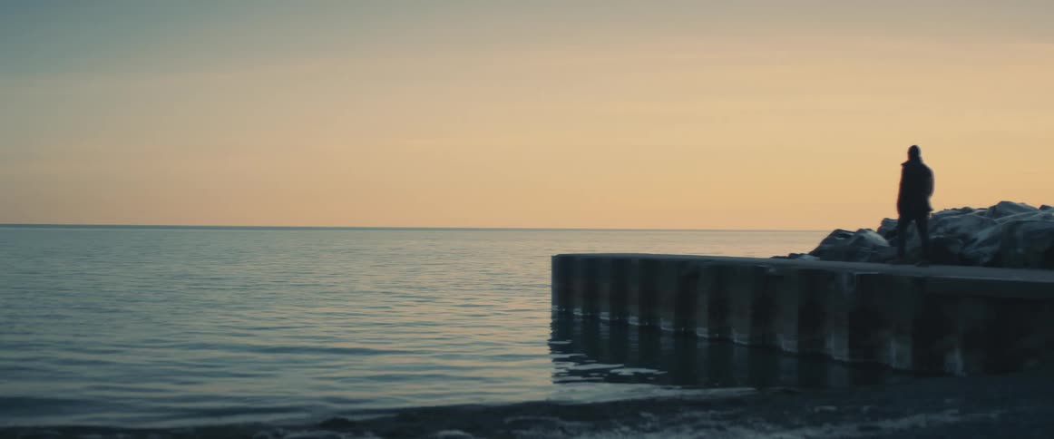 A man walking on a small pier