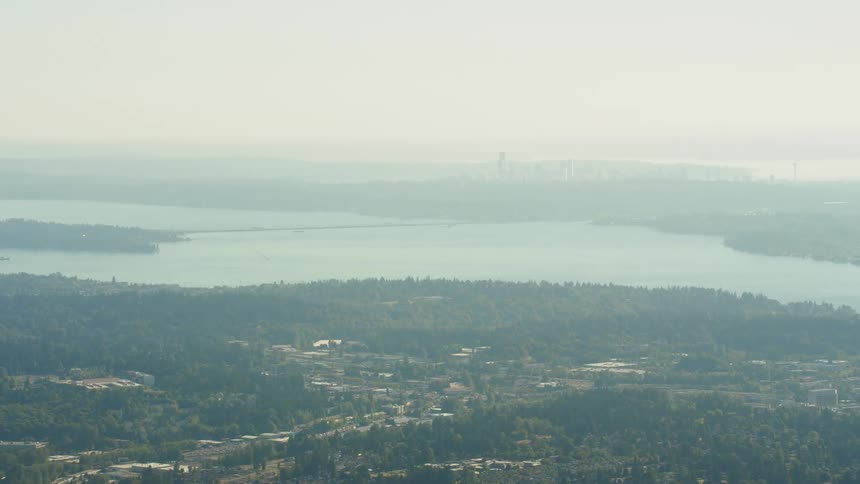 A haze obscures the air over a city by the sea
