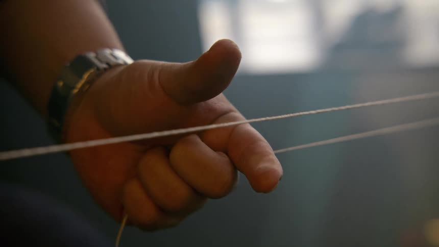 Person holds and releases a piece of string