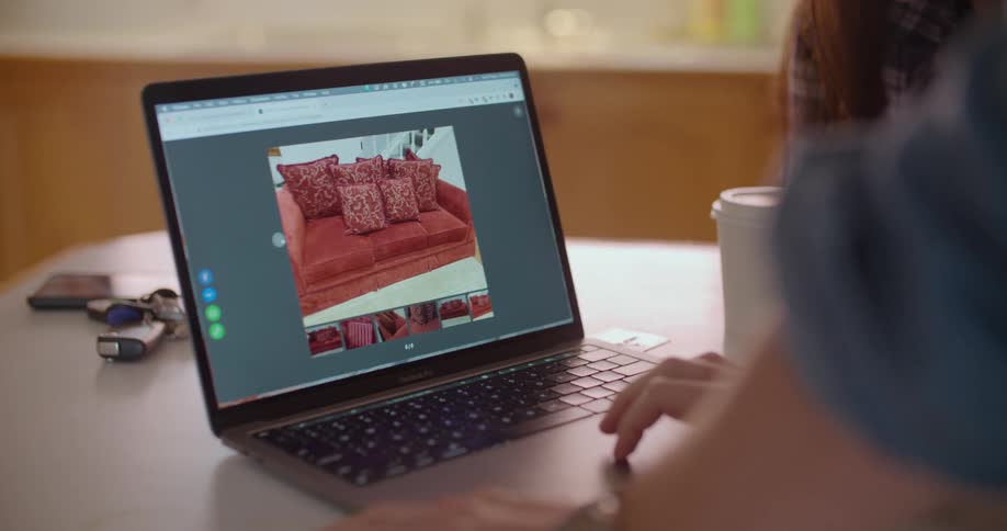 A man and woman looking at a laptop