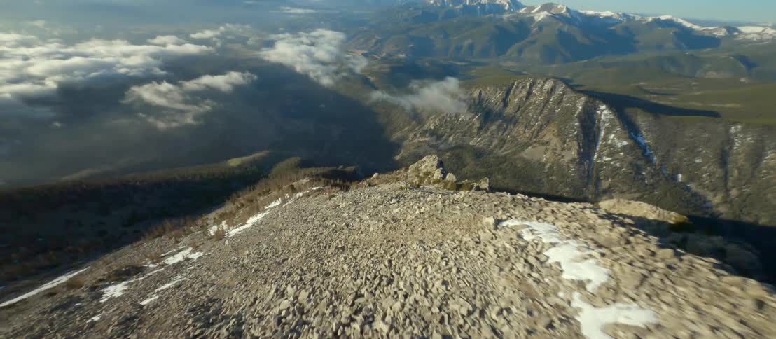 Aerial view of the barren passing slope on a mountain range at morning