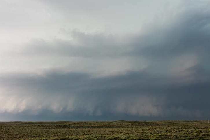 Dense clouds move over an open field