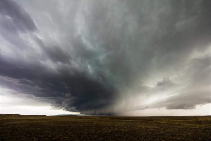Tornado clouds move in rotation and lightning flashes