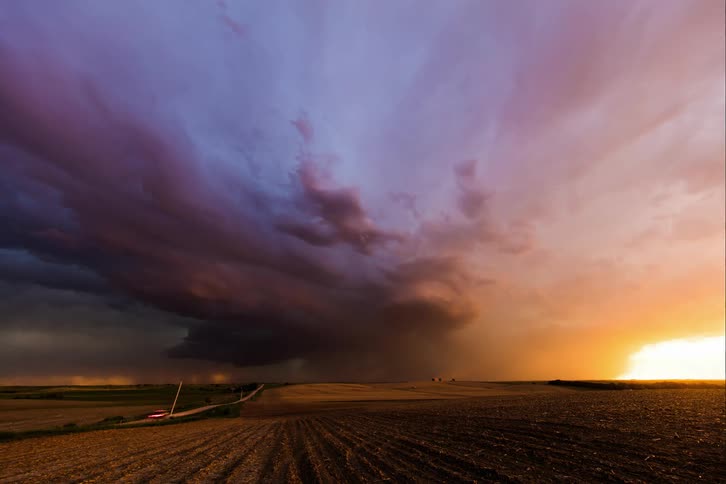 Thunderstorm rolling over the fields on the countryside at sunset