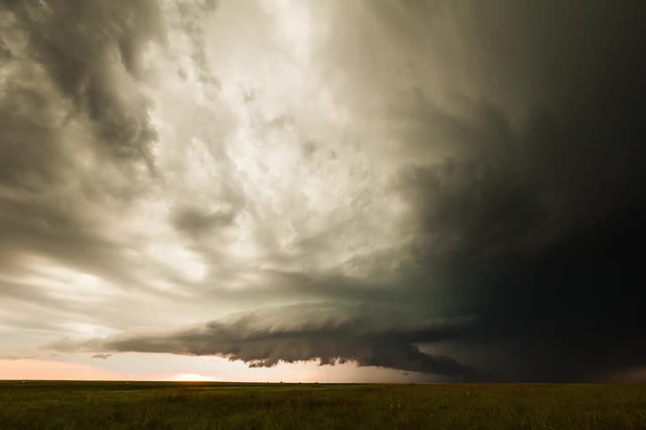 Large and ominous looking storm clouds gather in the sky as lighting flashes