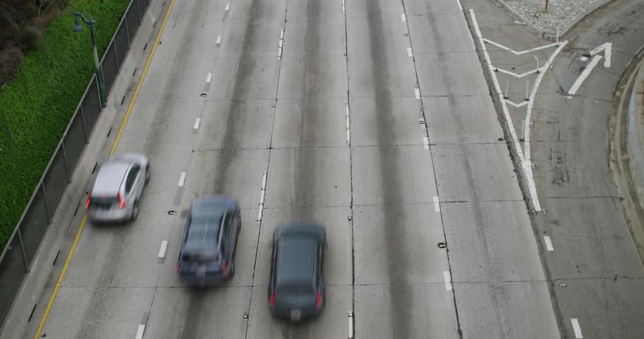 Vehicles driving down a five lane freeway