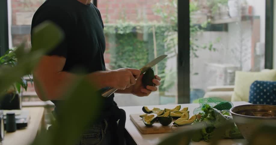 A man cutting an avocado