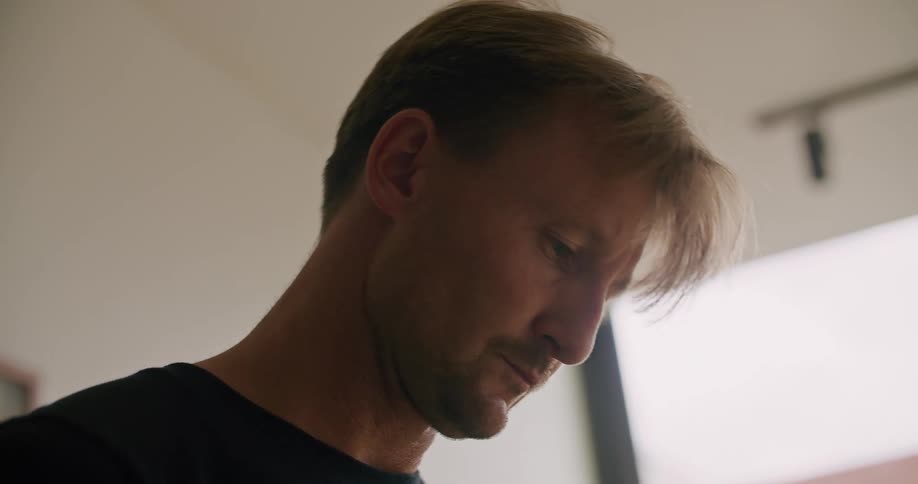 A man is looking around working on something