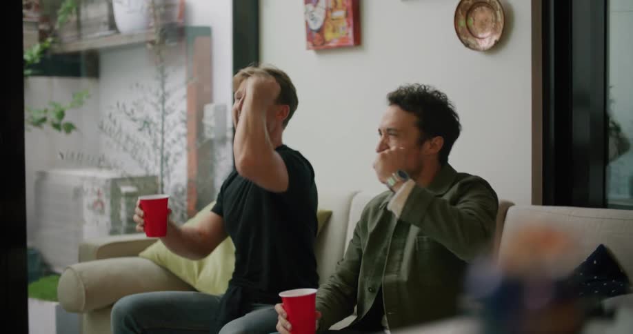 Two men sitting and watching