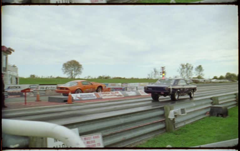Two cars racing in a drag race