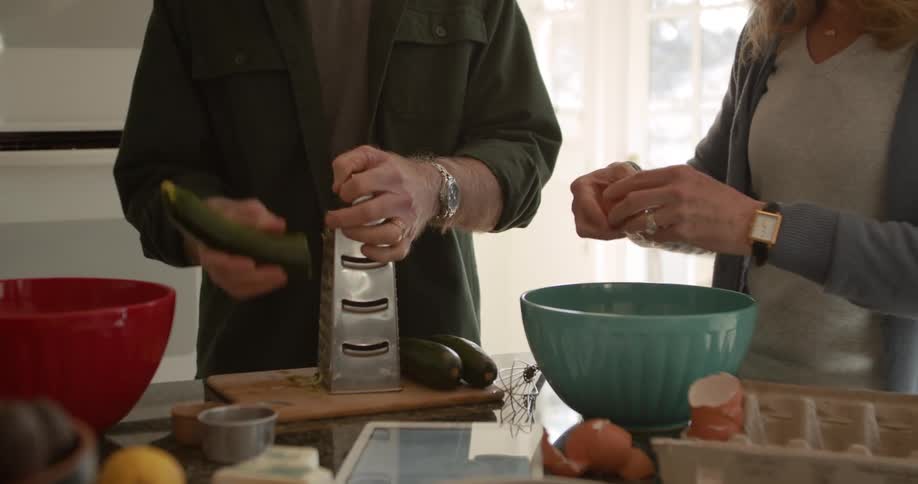 A couple cook in the kitchen