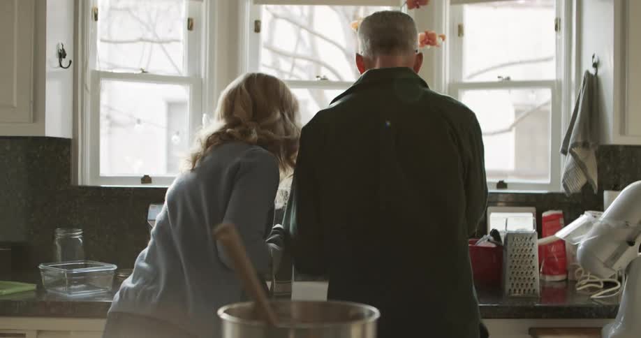 Couple washing dishes on the sink in the kitchen at home