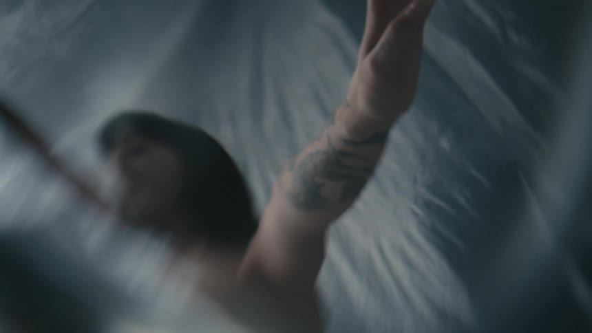 A woman is dancing under the plastic