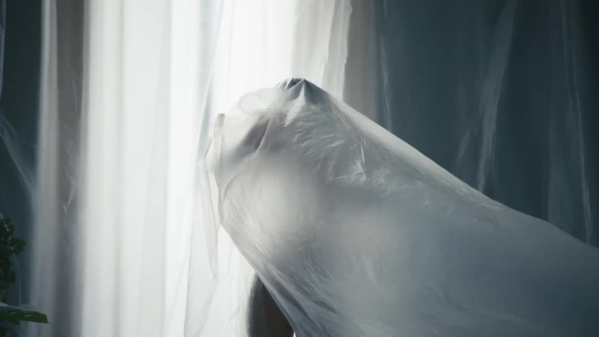 A woman dancing in a curtain