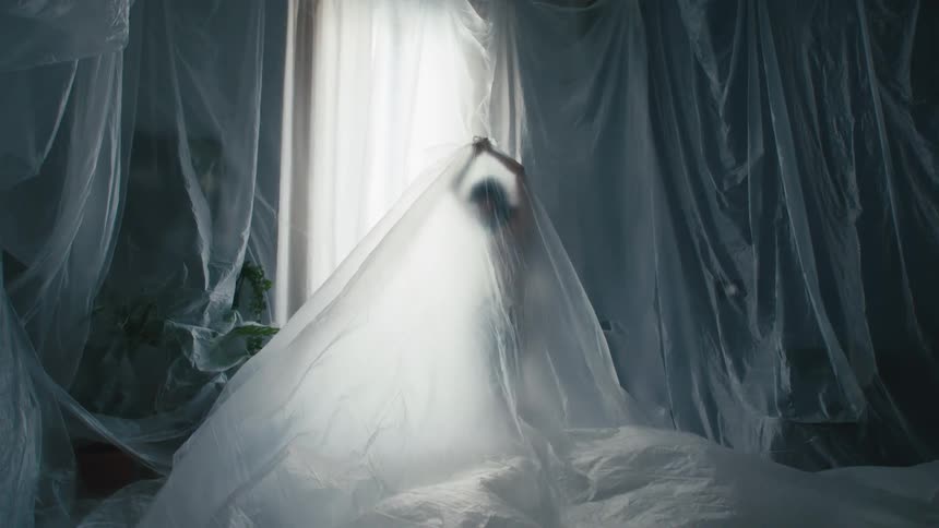 A model moves under plastic wrap