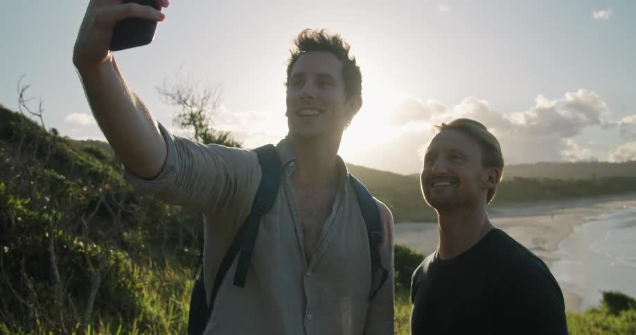 Two men taking a selfie outdoors