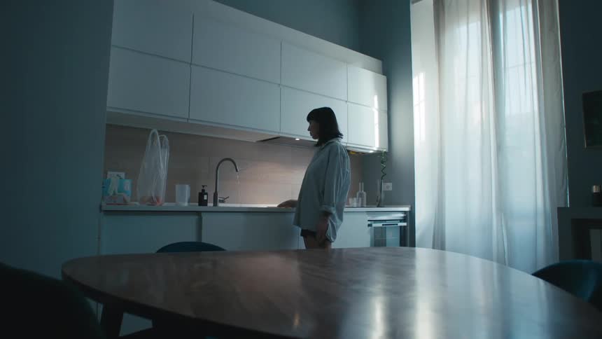 A woman standing in a kitchen