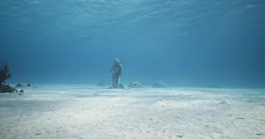 Underwater statue in the ocean with sand