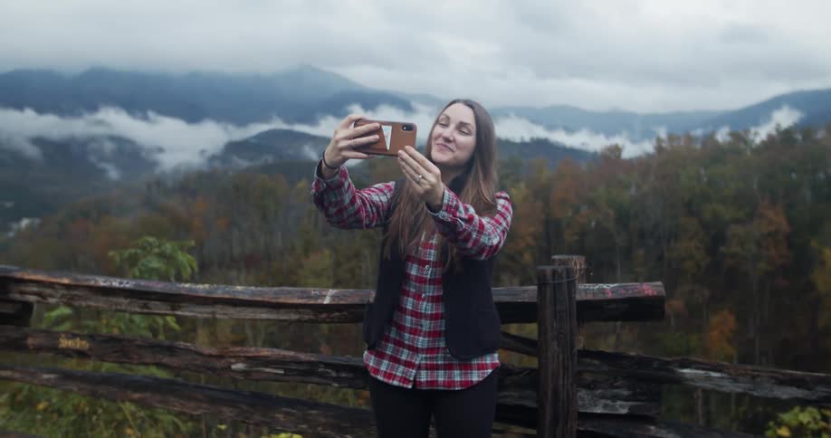 A woman taking a selfie in a forest