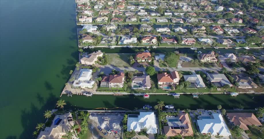 Overhead view of an affluent neighborhood with large bodies of water on both sides