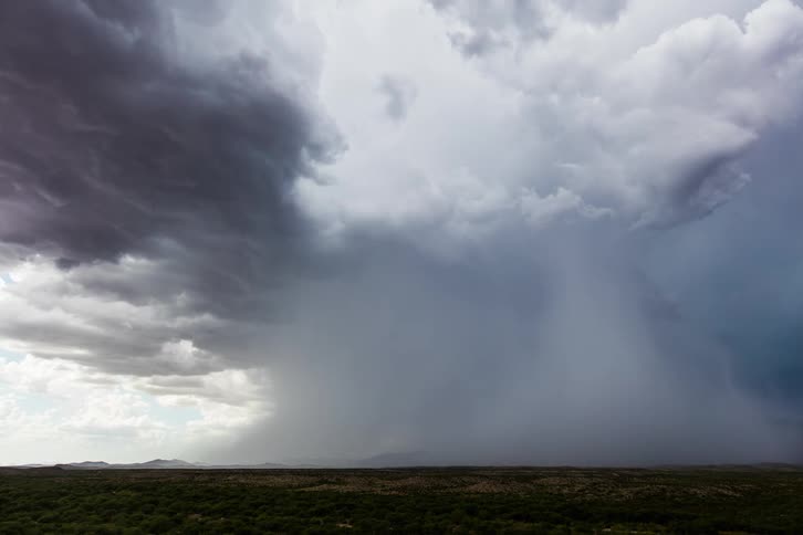 A time lapse of a rain storm over a field