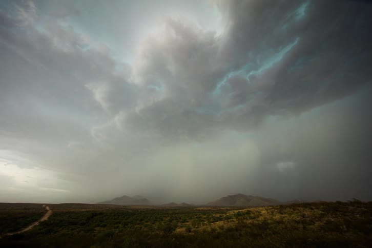 Storm clouds forming over a rural landscape