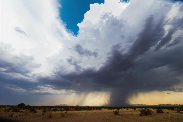 A view of a storm over grasslands and plains