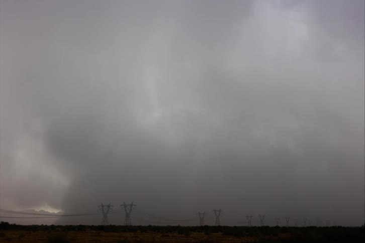 Storm clouds and rain over a field