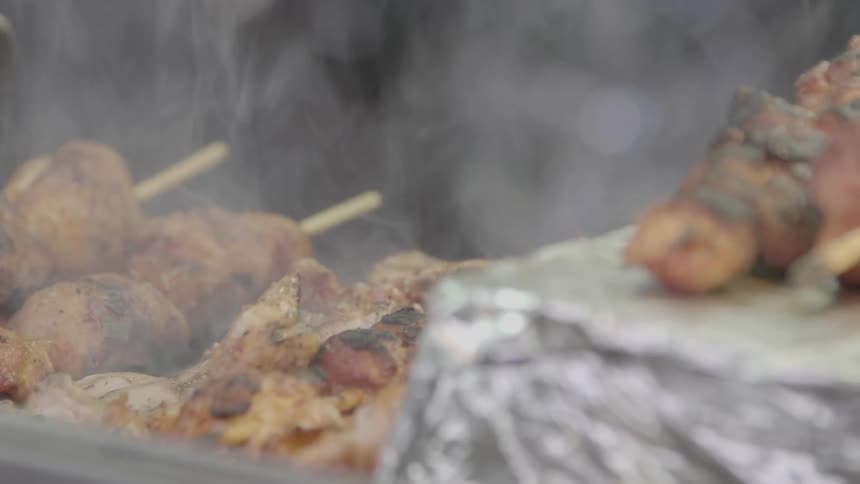 Kebabs being cooked upon a grill