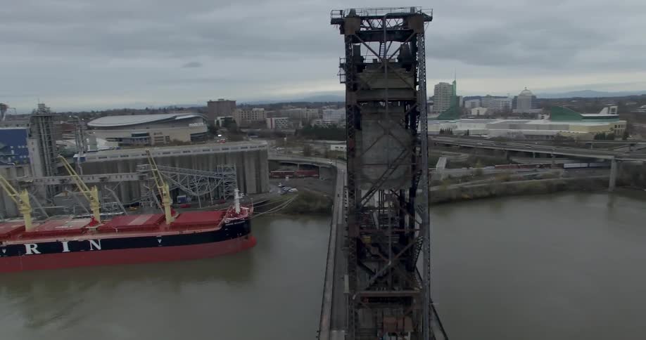 Large freighter docked next to a draw bridge