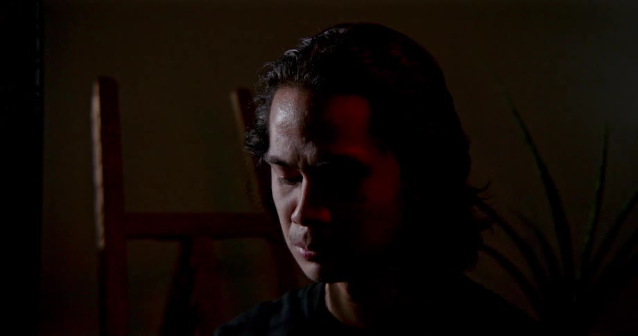 A man sitting meditating in a room