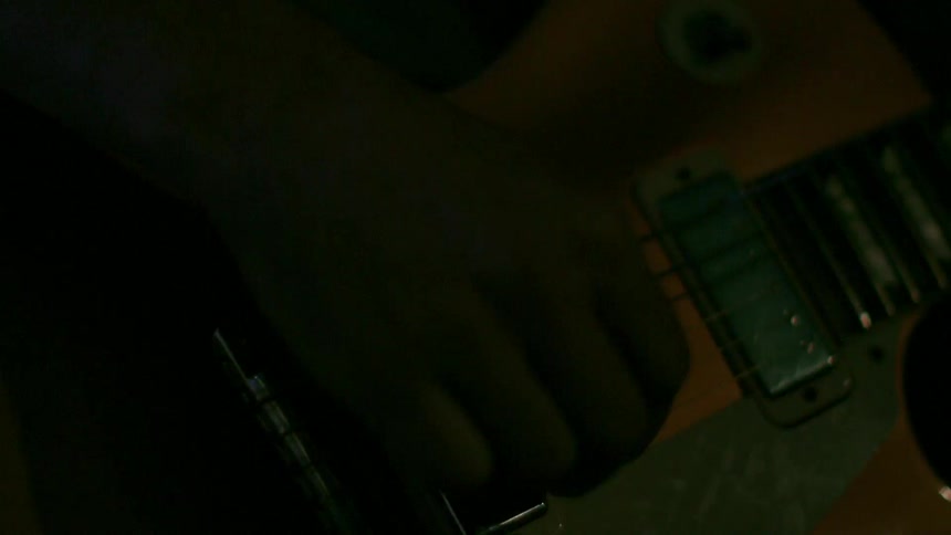 Close up of a guitar being strummed