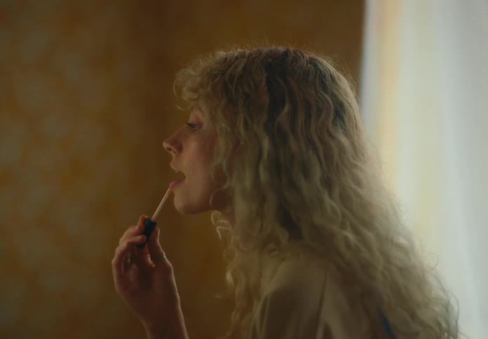 A woman putting on makeup