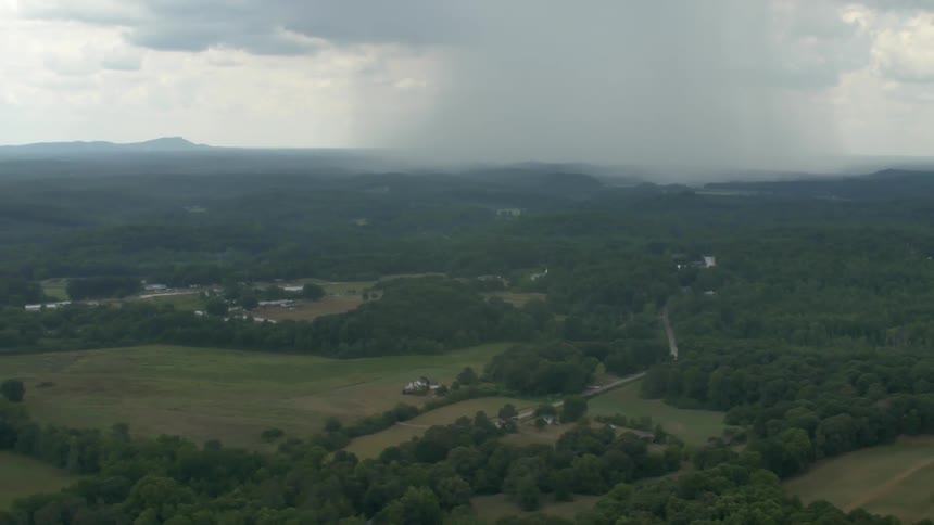 Aerial view of a wooded area with some houses spread out