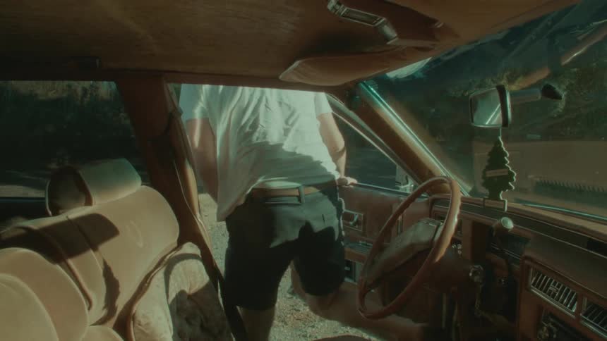 A man stops the car and gets out