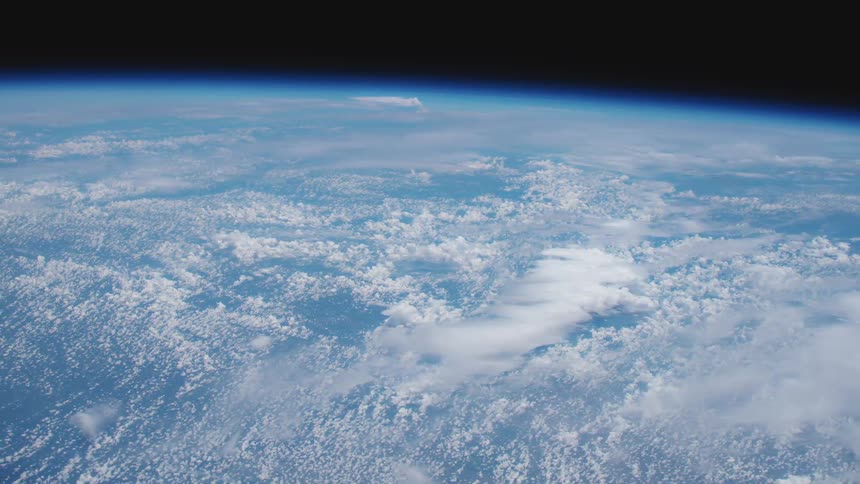 The curve of blue and white earth against the black of outer space