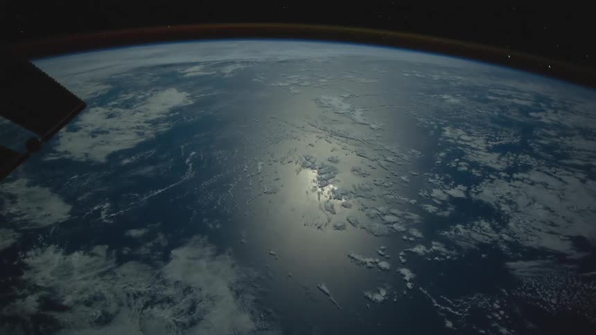 The sun is reflecting off the water on the earth
