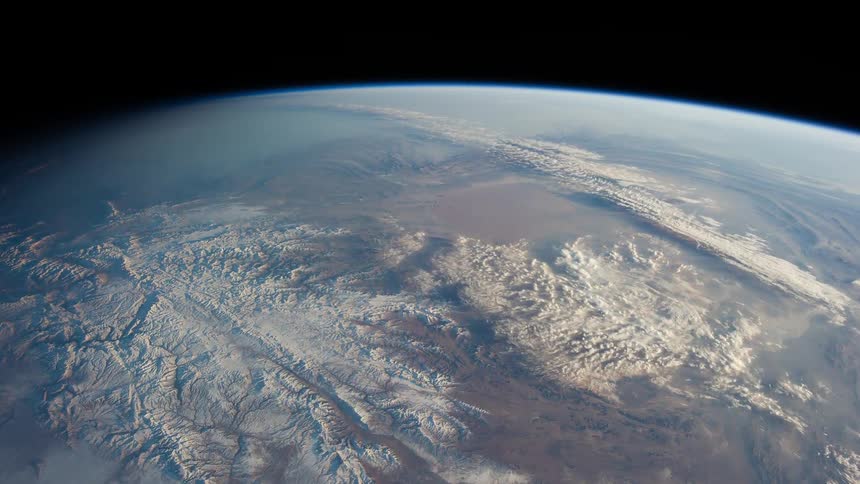 Clouds over mountans and deserts on the earth landscape seen from space