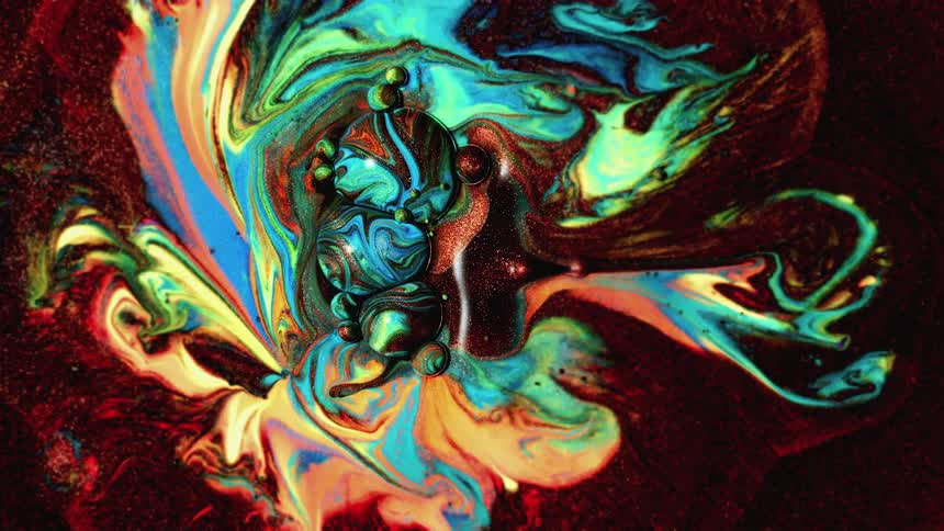 A variety of colors of paint move together in a fractal design