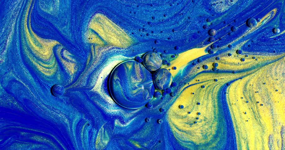 A close up footage of a blue and yellow paint mix