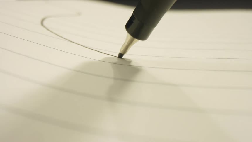 A pen draws a line on paper