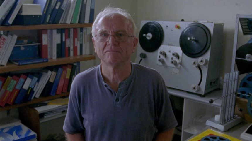 A man is standing in front of a machine