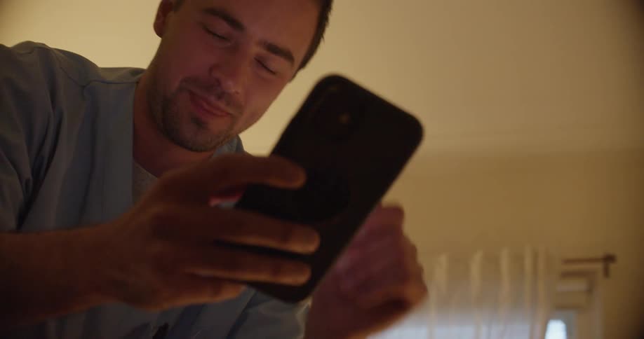 A man talking on a smartphone in a room