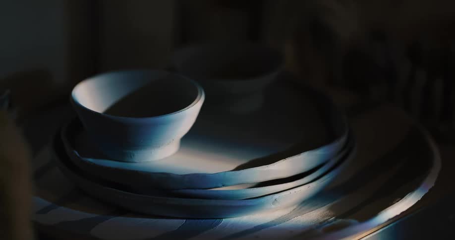 Sunlight shines on pottery on a table
