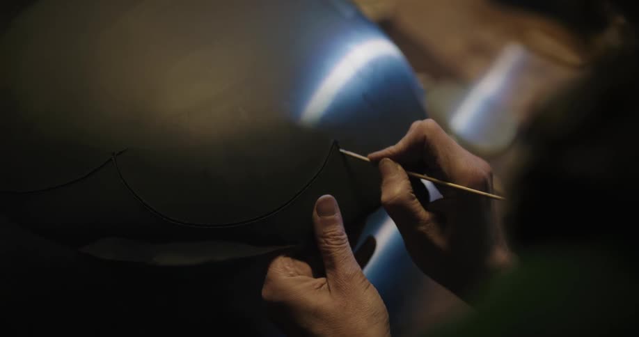 A person is etching in a shop