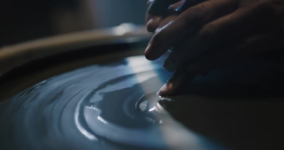 A person is sculpting clay