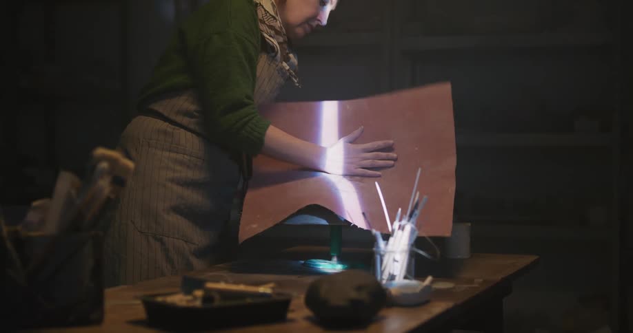 A sculptor working in a studio